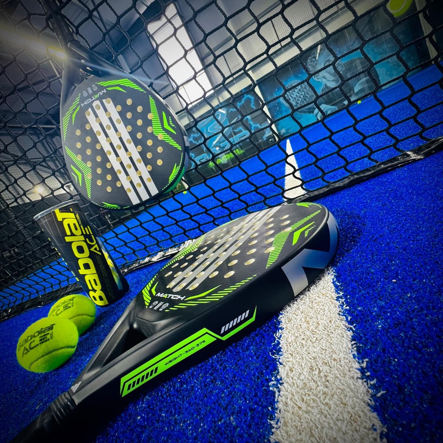 Padel court with racket and ball at RAZR